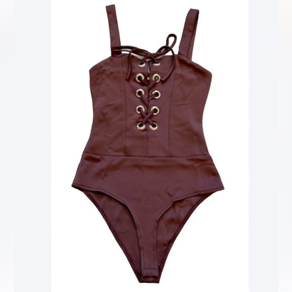 Charlotte Russe Tops - CHARLOTTE RUSSE burgundy one piece lace up bodysuit. New condition. Bottom snaps